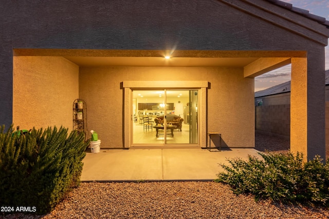 exterior entry at dusk with a patio area