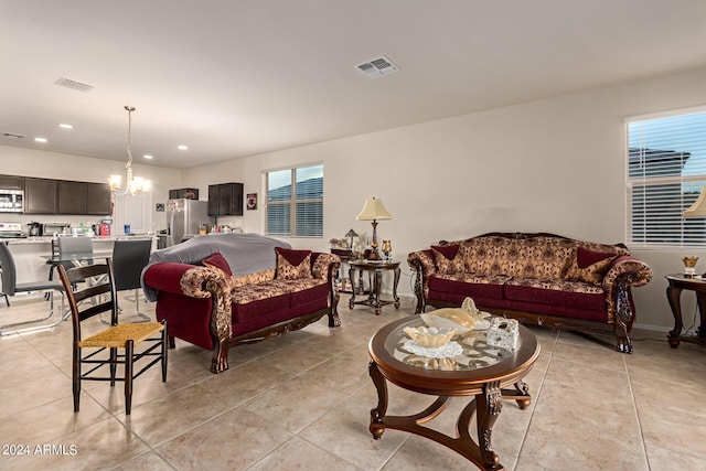 living room featuring a notable chandelier and light tile patterned floors