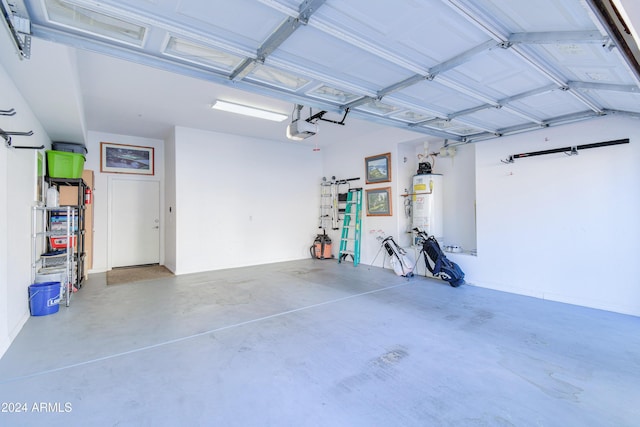 garage featuring a garage door opener and water heater