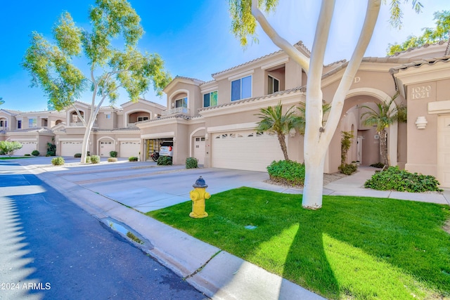 view of front of property featuring a front yard and a garage