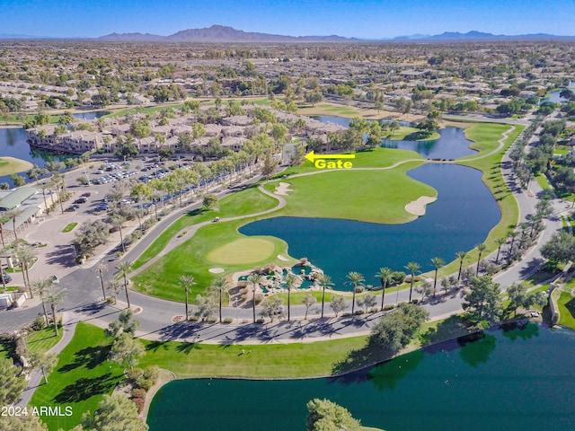 birds eye view of property with a water and mountain view