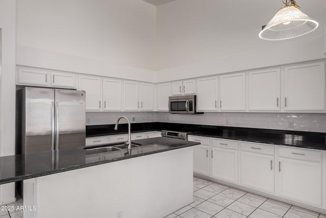 kitchen featuring a sink, marble finish floor, appliances with stainless steel finishes, and white cabinets