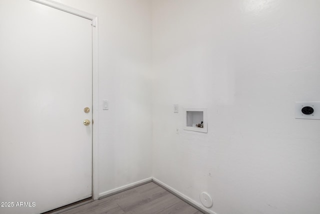 laundry area featuring laundry area, baseboards, hookup for a washing machine, light wood-type flooring, and hookup for an electric dryer