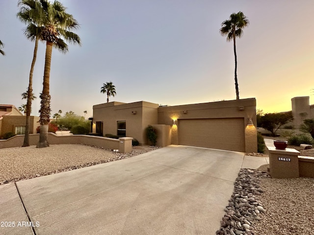 pueblo-style home with a garage