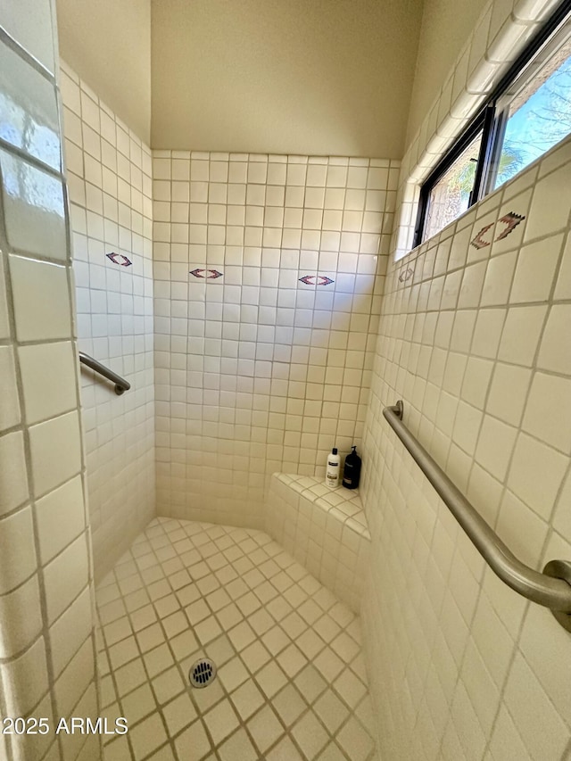 bathroom with tiled shower