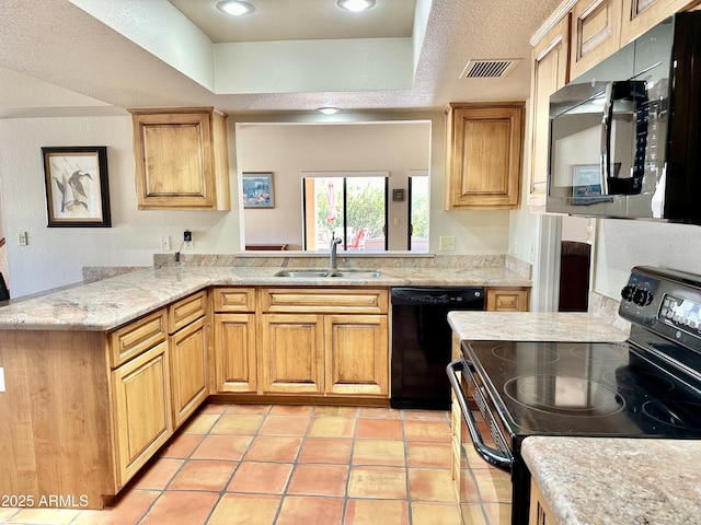 kitchen with black appliances, kitchen peninsula, light tile patterned floors, a tray ceiling, and sink