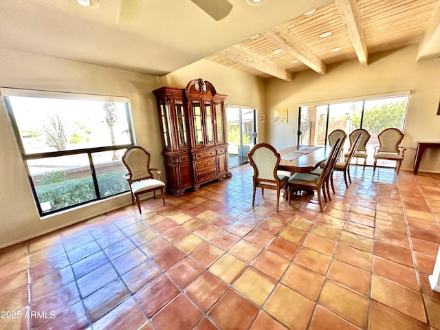 dining space with wooden ceiling, ceiling fan, light tile patterned floors, and beamed ceiling