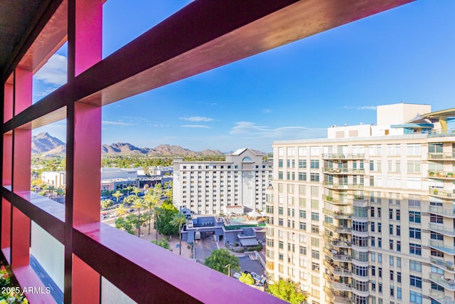 balcony with a mountain view and a city view