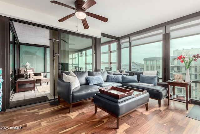 sunroom / solarium featuring ceiling fan