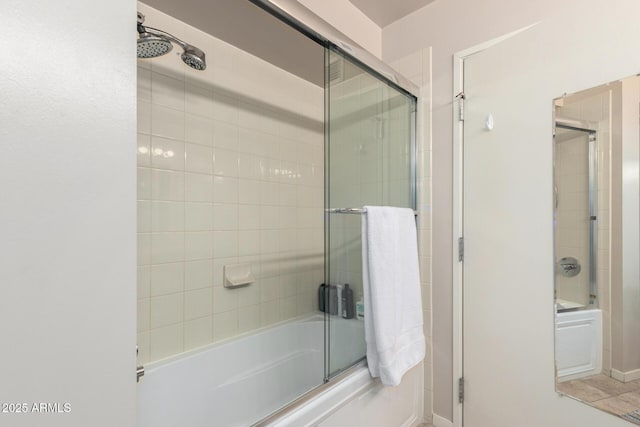 full bathroom with bath / shower combo with glass door