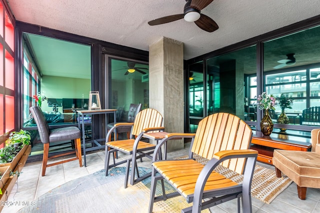 sunroom featuring a ceiling fan