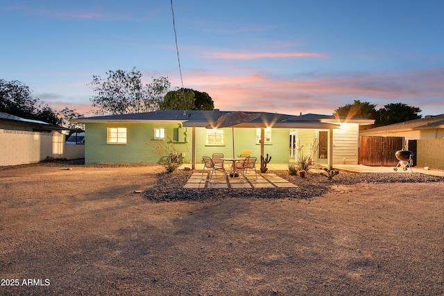 805 E Jackson Ave, Buckeye, AZ 85326 - back of property at dusk featuring a patio