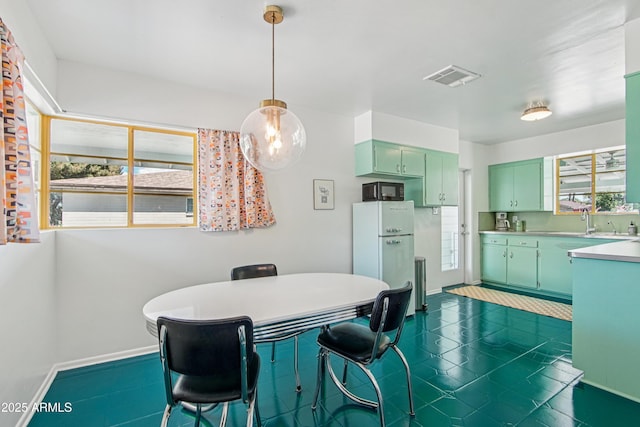 805 E Jackson Ave, Buckeye, AZ 85326 - dining space featuring baseboards and dark tile patterned floors