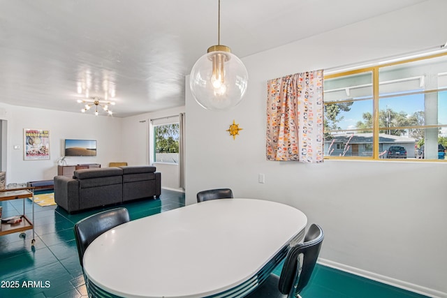 805 E Jackson Ave, Buckeye, AZ 85326 - dining space with baseboards and a chandelier