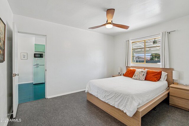 805 E Jackson Ave, Buckeye, AZ 85326 - bedroom with baseboards, a ceiling fan, fridge, and dark carpet