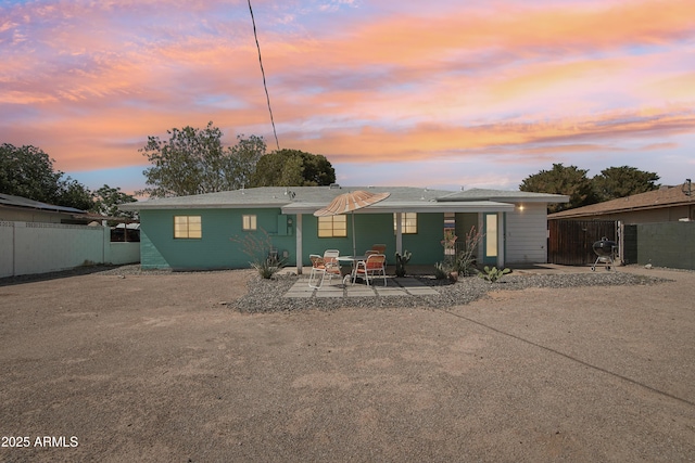 805 E Jackson Ave, Buckeye, AZ 85326 - back of property at dusk featuring a patio area