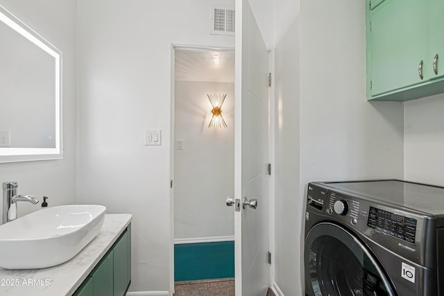 805 E Jackson Ave, Buckeye, AZ 85326 - washroom featuring washer / clothes dryer, baseboards, and cabinet space