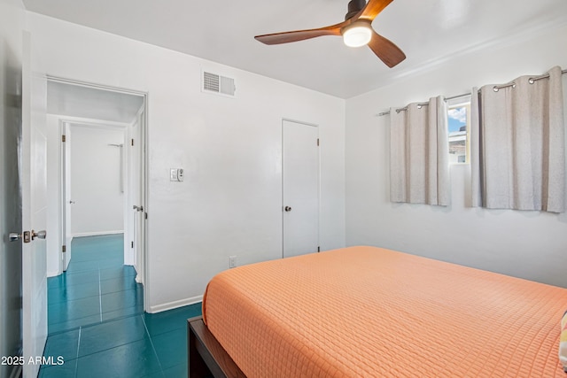 805 E Jackson Ave, Buckeye, AZ 85326 - bedroom featuring a ceiling fan, dark tile patterned floors, and baseboards