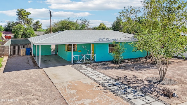 805 E Jackson Ave, Buckeye, AZ 85326 - view of front of home featuring concrete driveway, a carport, and roof with shingles