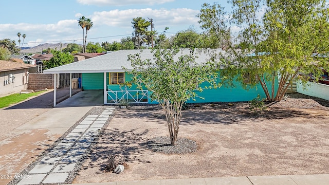 805 E Jackson Ave, Buckeye, AZ 85326 - view of front of house featuring driveway, a shingled roof, a mountain view, and a carport