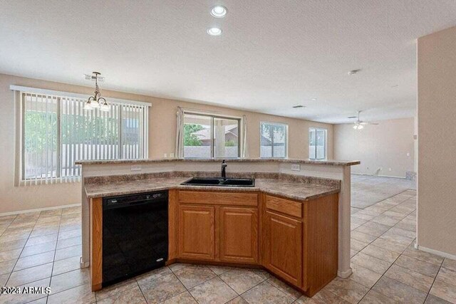 kitchen featuring ceiling fan with notable chandelier, a textured ceiling, sink, pendant lighting, and black dishwasher