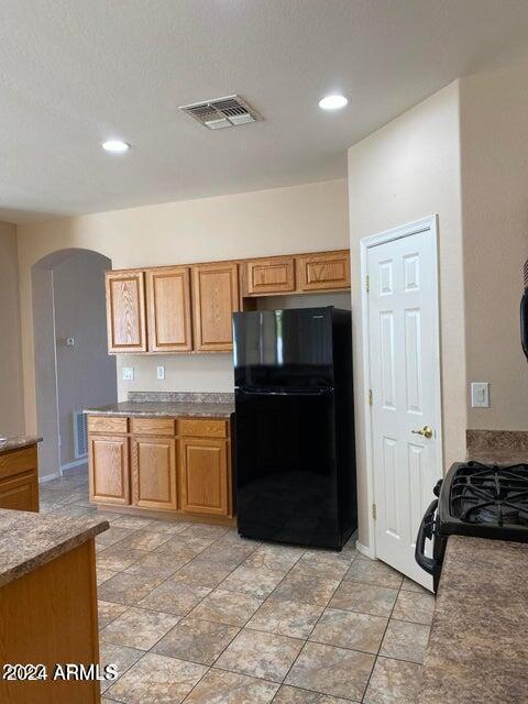 kitchen with black appliances and a textured ceiling