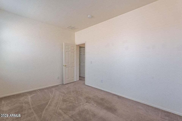 unfurnished room featuring light carpet