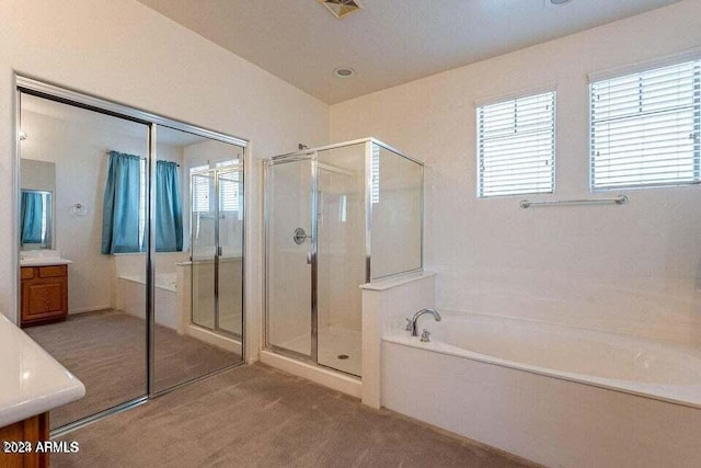 bathroom featuring separate shower and tub and vanity