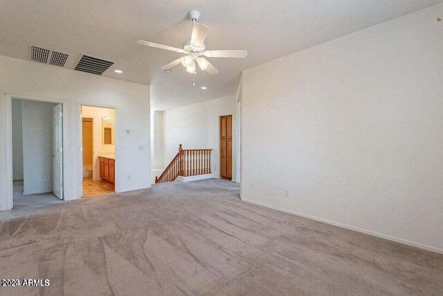 spare room with light carpet and ceiling fan