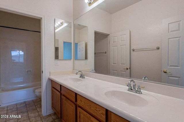 full bathroom featuring washtub / shower combination, vanity, and toilet