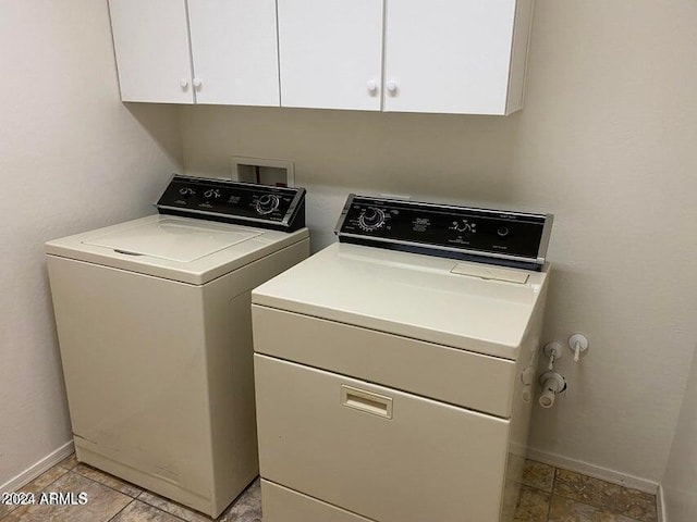 washroom featuring cabinets and washer and dryer