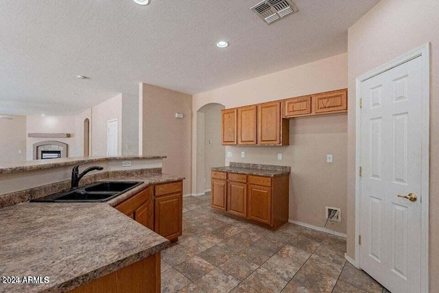 kitchen featuring a textured ceiling and sink