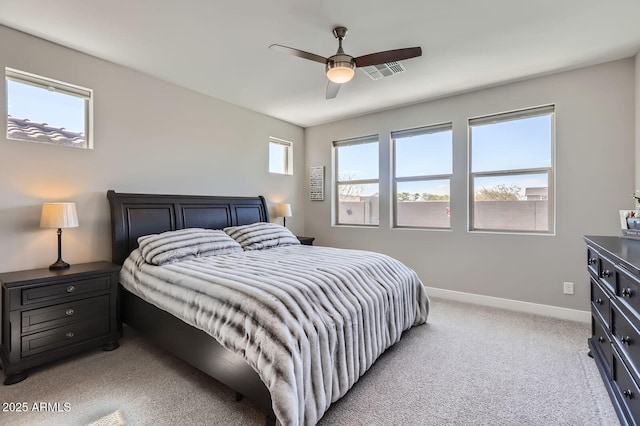 bedroom with a ceiling fan, light colored carpet, visible vents, and baseboards