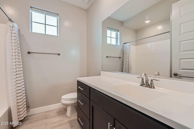 full bath featuring curtained shower, baseboards, toilet, wood finished floors, and vanity