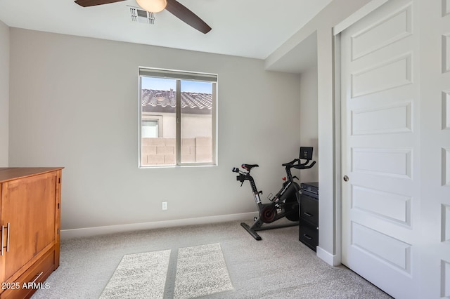 workout room featuring light colored carpet, baseboards, and ceiling fan