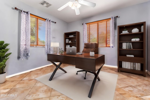 tiled home office with visible vents, baseboards, and a ceiling fan