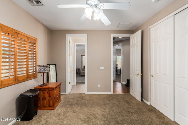 bedroom with baseboards, visible vents, carpet floors, and a closet