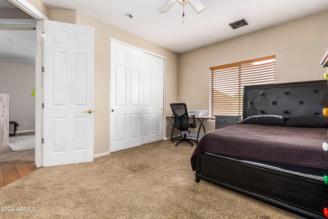 bedroom with ceiling fan, hardwood / wood-style floors, and a closet