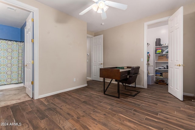 office space with dark wood-style floors, visible vents, ceiling fan, and baseboards