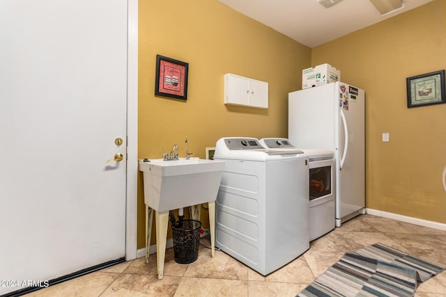 laundry room featuring washing machine and dryer and baseboards