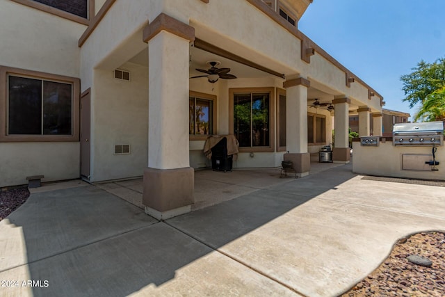 view of patio featuring visible vents, an outdoor kitchen, a grill, and ceiling fan