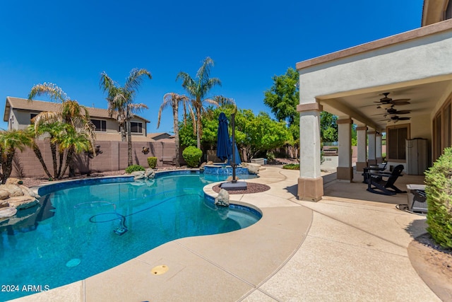 view of pool featuring a ceiling fan, a patio, a fenced backyard, and a pool with connected hot tub