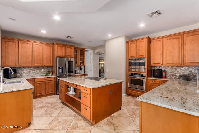 kitchen with a sink, visible vents, a kitchen island, and stainless steel fridge with ice dispenser