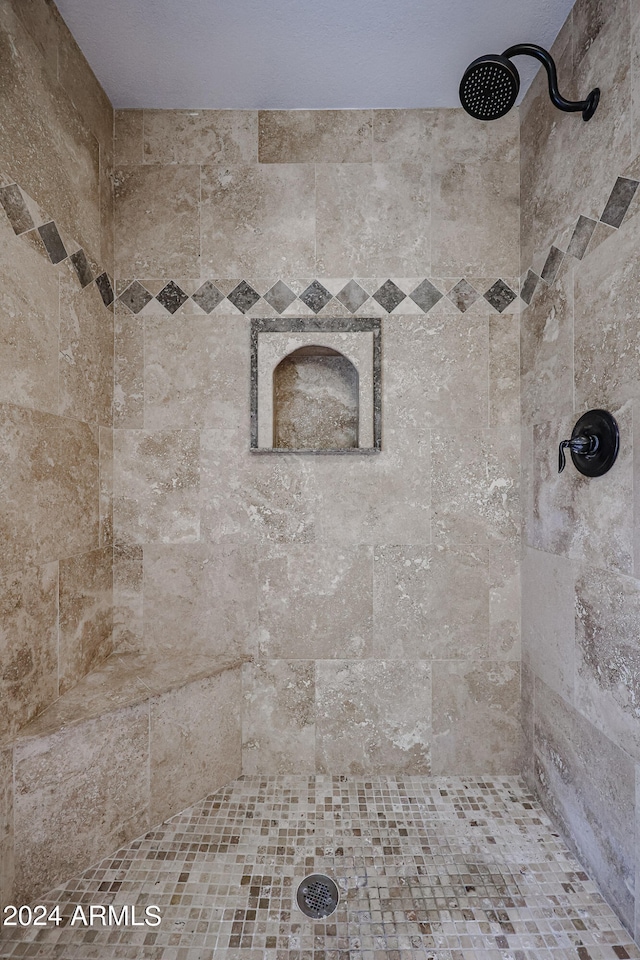 bathroom featuring tiled shower