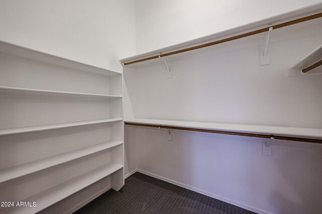 carpeted spare room featuring lofted ceiling and ceiling fan