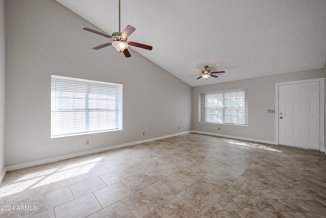 tiled spare room with lofted ceiling, ceiling fan, and baseboards