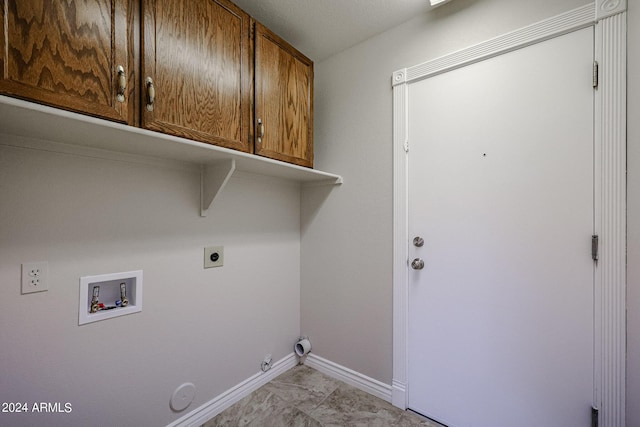 laundry area with cabinet space, baseboards, gas dryer hookup, hookup for an electric dryer, and washer hookup