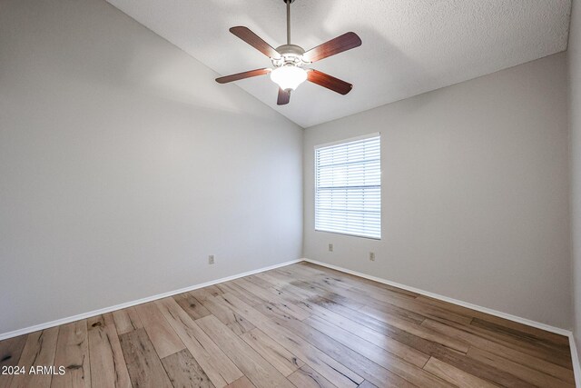 garage featuring a garage door opener, ceiling fan, and water heater