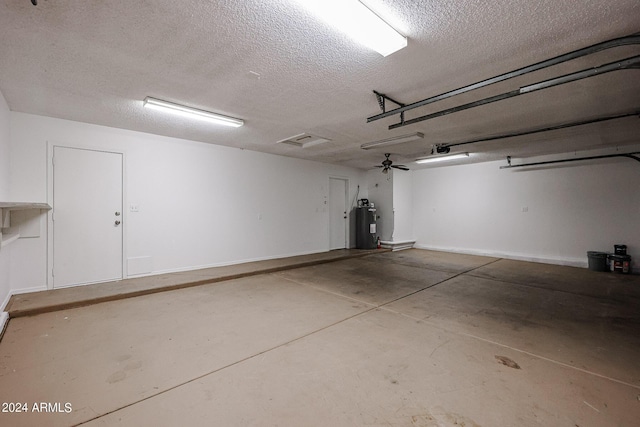 garage with electric water heater and baseboards