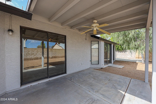 view of patio / terrace with ceiling fan and fence